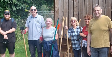 Worsbrough Mill volunteer group, stood together outside tool shed