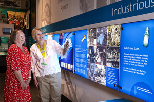 Volunteer showing visitor around the Experience Barnsley Museum